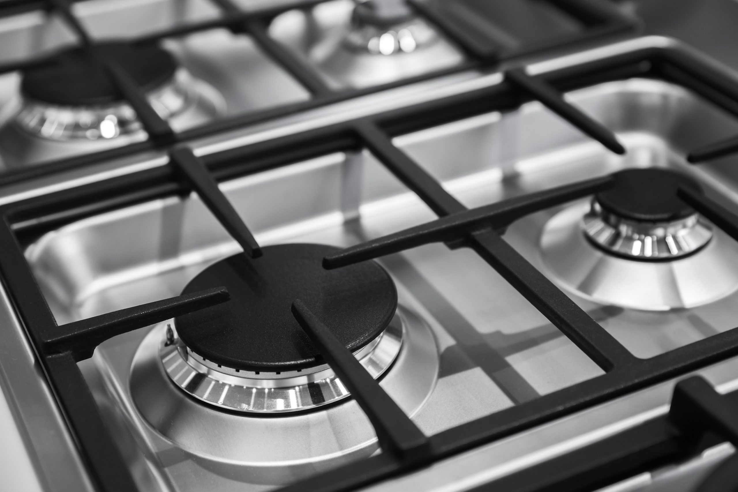 Close-up of a gas cooktop burner and grate